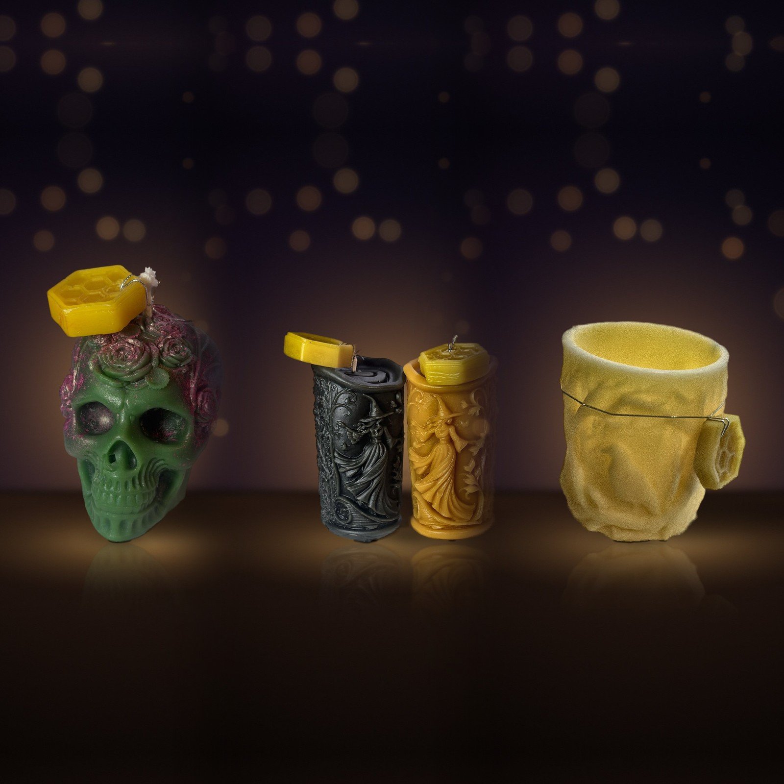 Maine beeswax rose skull, witch pillars and raven luminary side by side · Hallows Pack