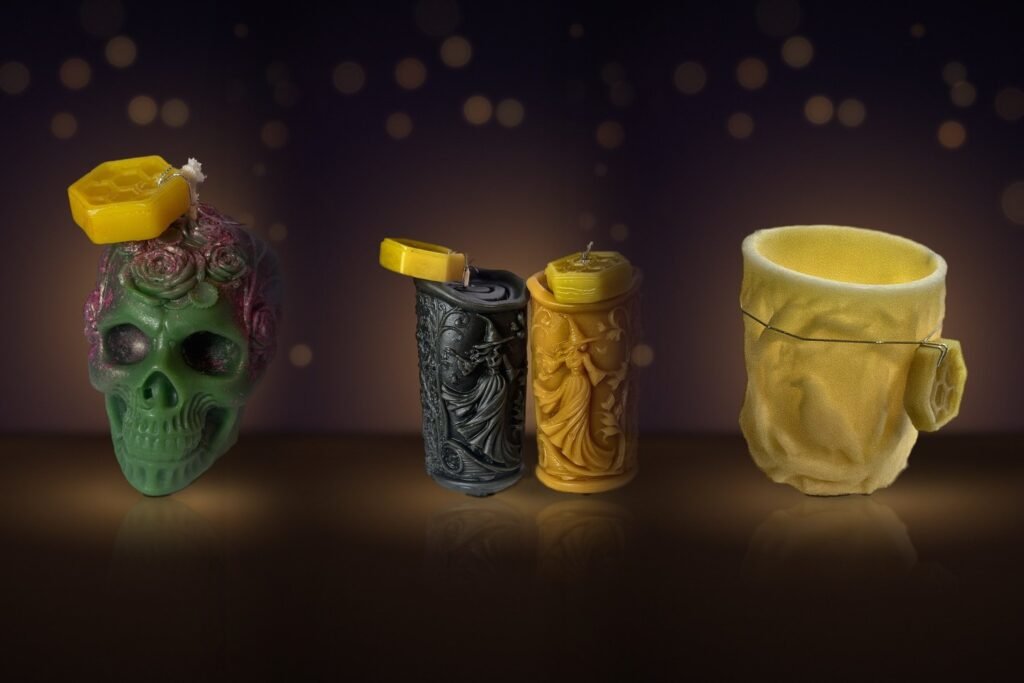 Maine beeswax rose skull, witch pillars and raven luminary side by side · Hallows Pack