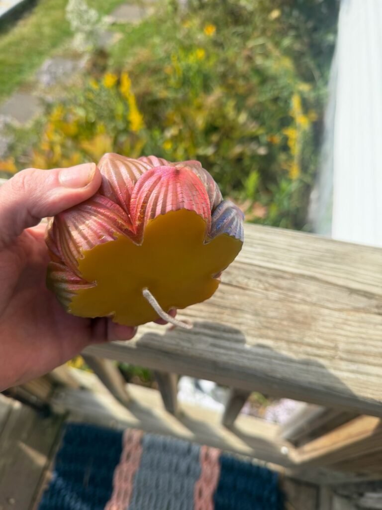 Underside of the flower candle showing natural beeswax under the painted mica