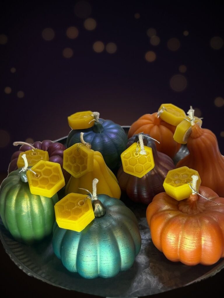 Conway Candle Sanctuary beeswax pumpkin and gourd candles with mica finishes in teal, green, orange, plum and copper, each with a yellow honeycomb beeswax tag